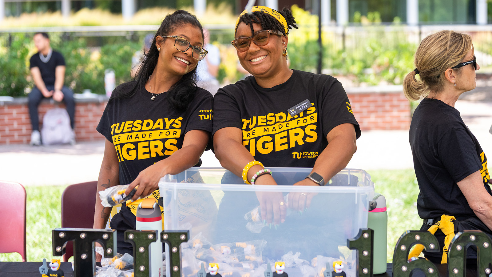 TU staff in Tiger Tuesday shirts handing out giveaways