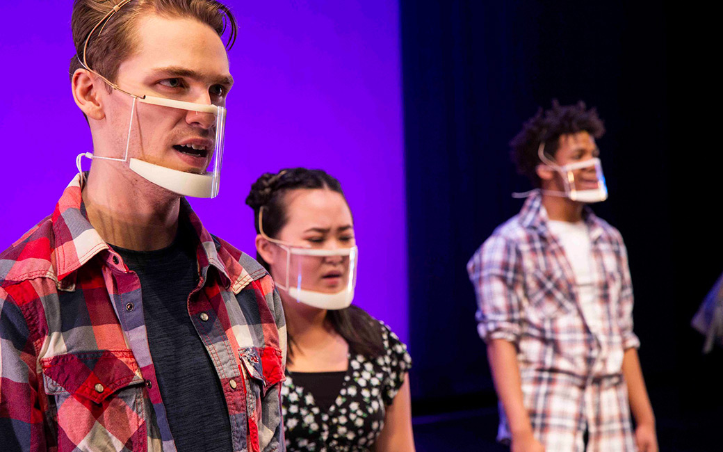 Close-up of students performing in clear masks