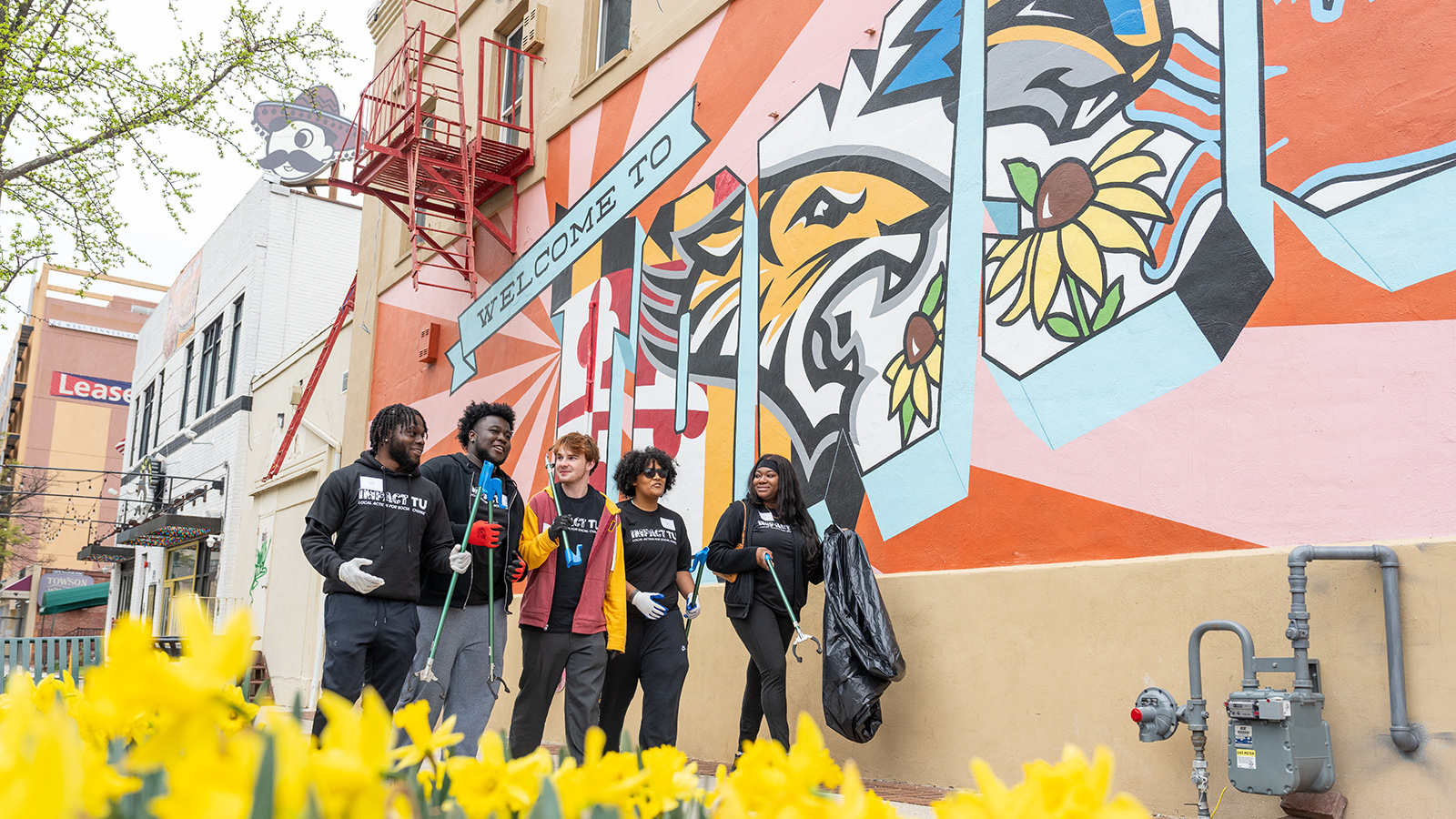 Five people volunteering in the community