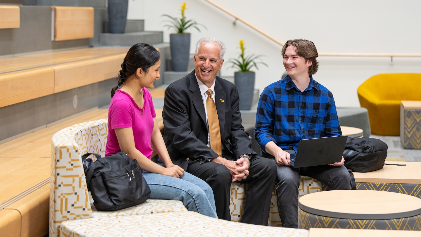 TU president Mark Ginsberg sits and talks with students