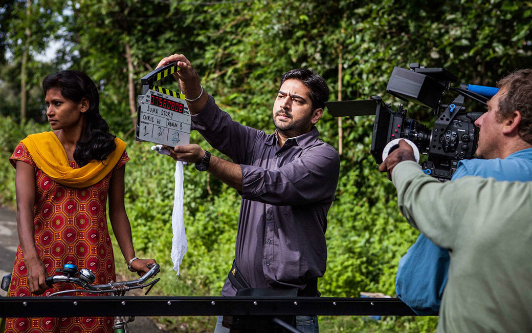 Woman on bike with clapperboard and camera