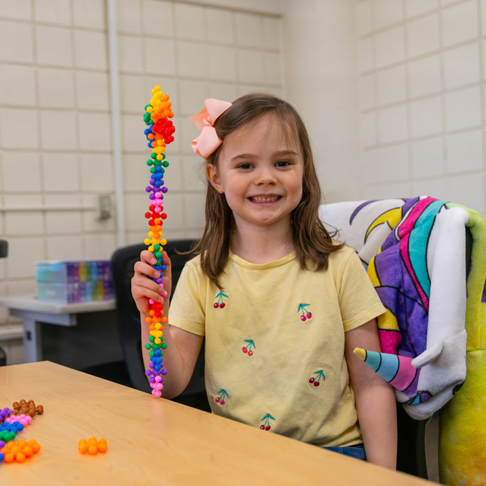 An elementary school student participating in a fun exercise with colorful puzzle pieces