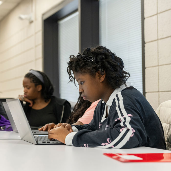 A high school student works on a coding exercise
