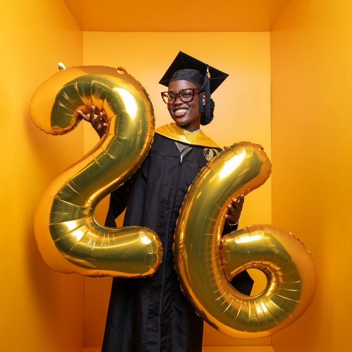 Sunmisola Balogun, 2026 Towson University graduate holding balloons