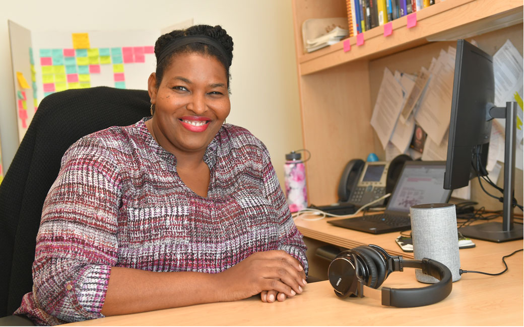 Halcyon Lawrence sitting at desk