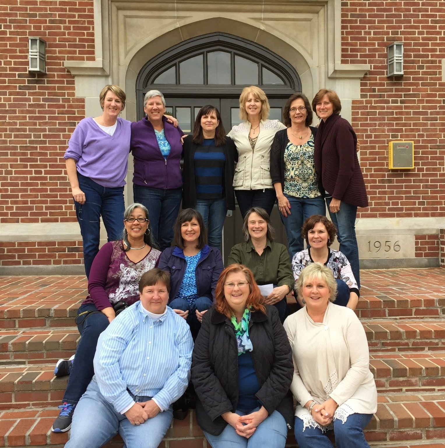 A group of alumni posing on the front steps of Stephens Hall