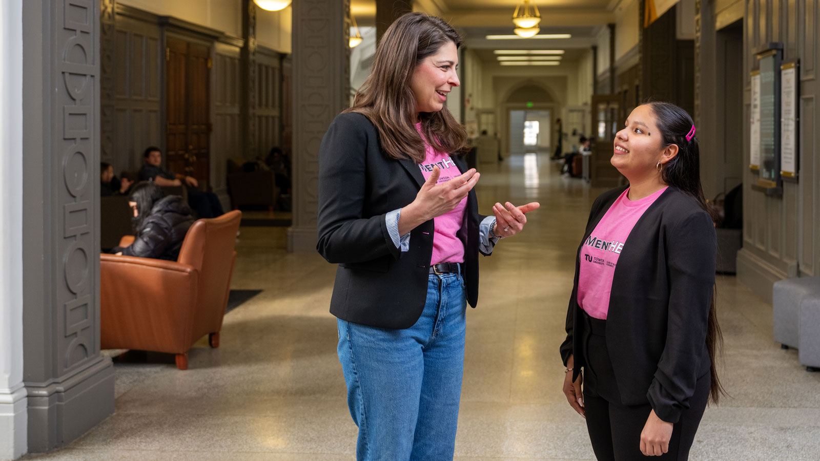 MentHER facilitator Lauren Tigue Meredith talking with student Helen Santos-Melendez
