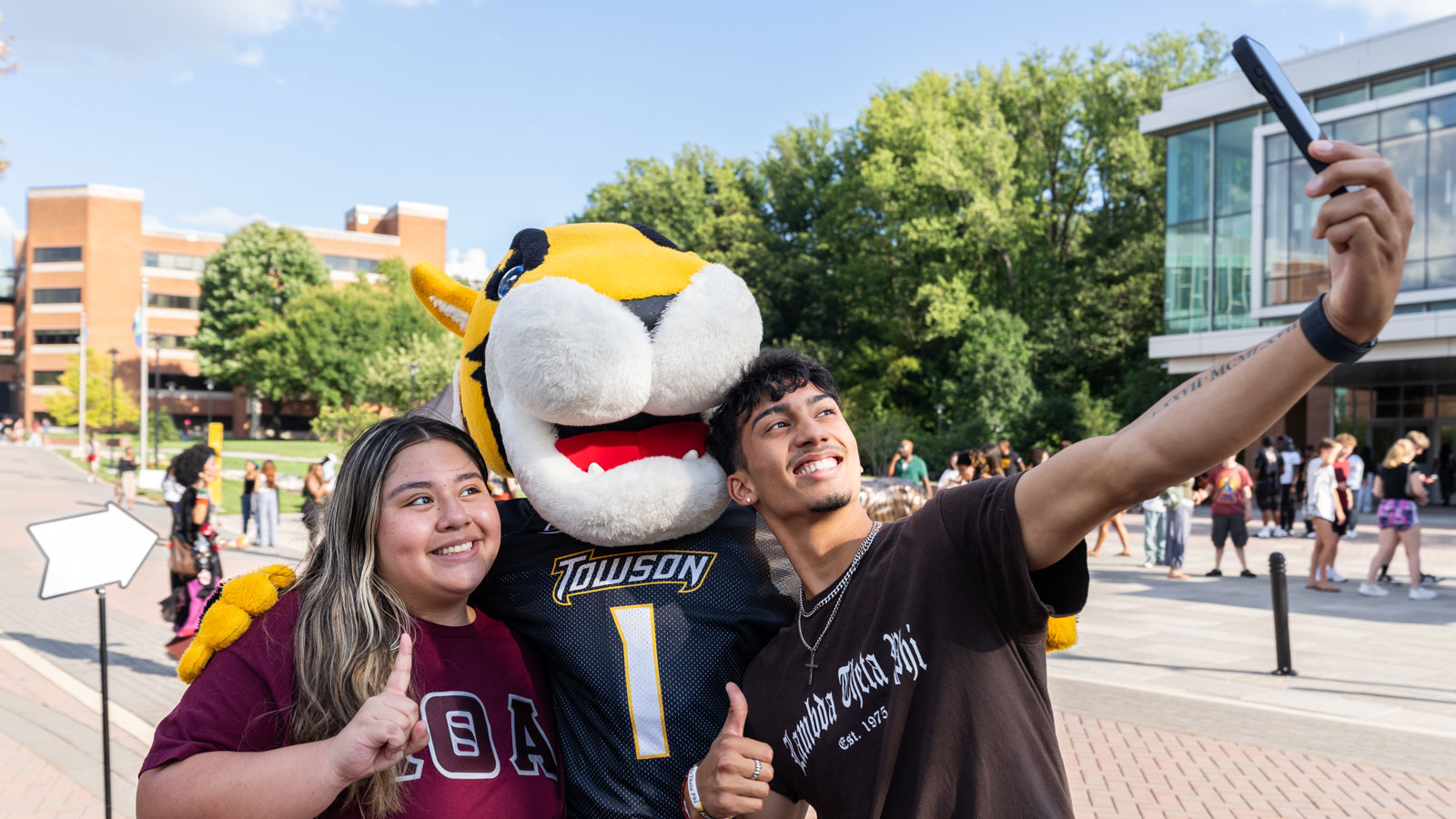 Doc taking a selfie with two students