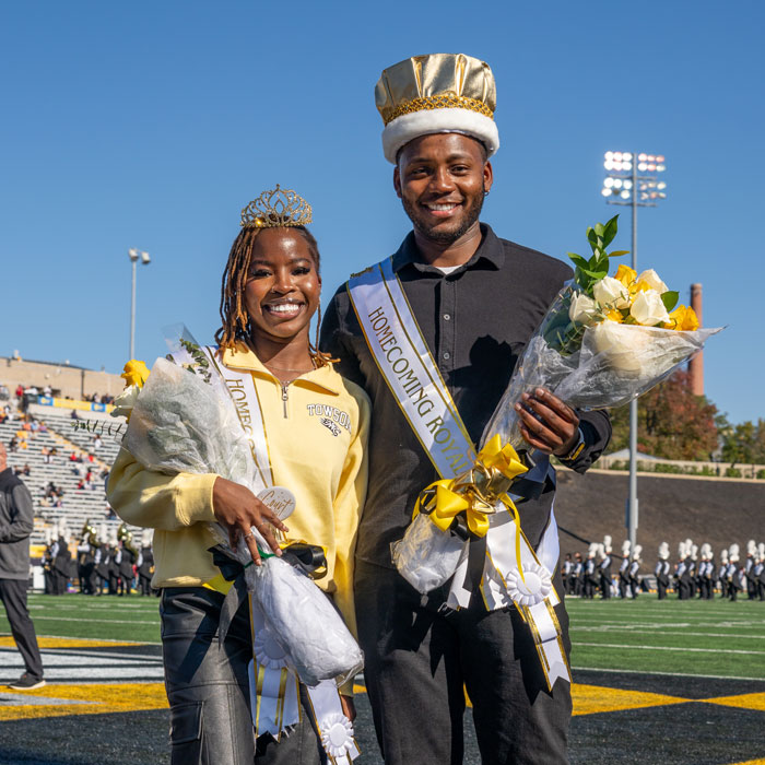 Homecoming queen and king stand in the TU stadium
