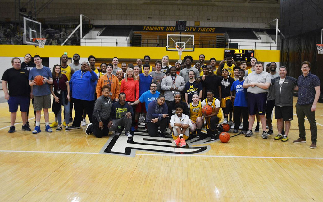 The Towson University men's and women's basketball team with members of the Hussman Center for Adults with Autism