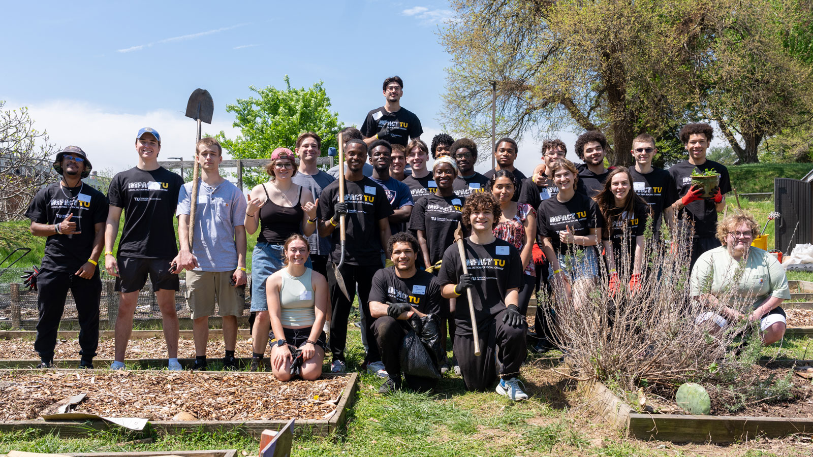 Students with the Brazilian Jiu Jitsu club and Greek Life at the Urban Farm on campus