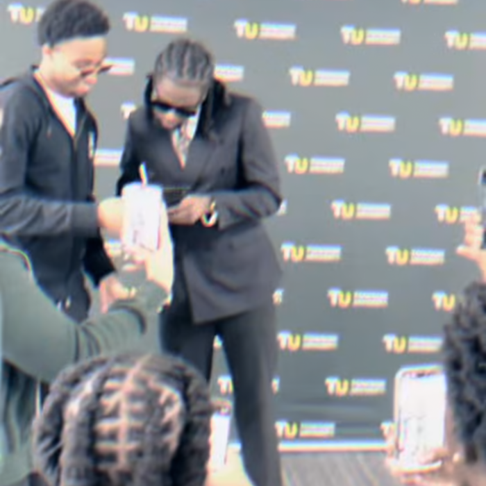 Towson University Career Center employee signing a fake autograph