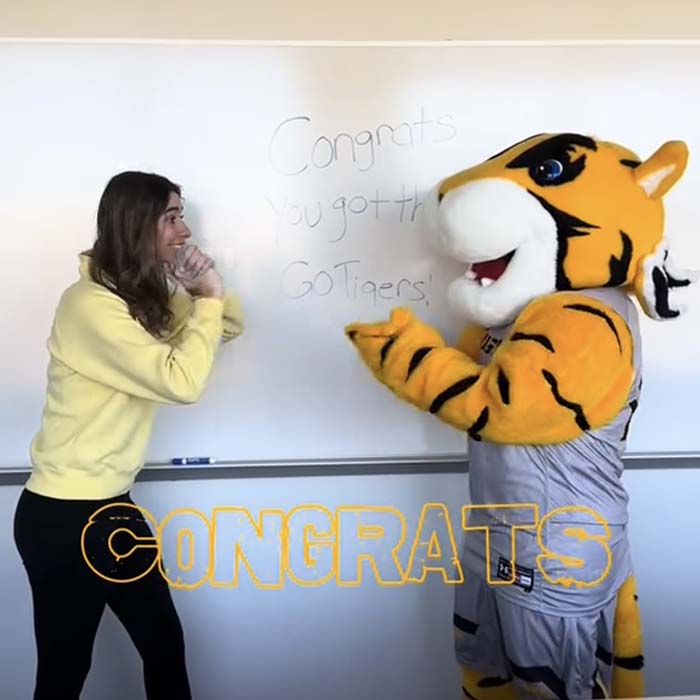 Doc and a professor with text overlay saying "congrats"