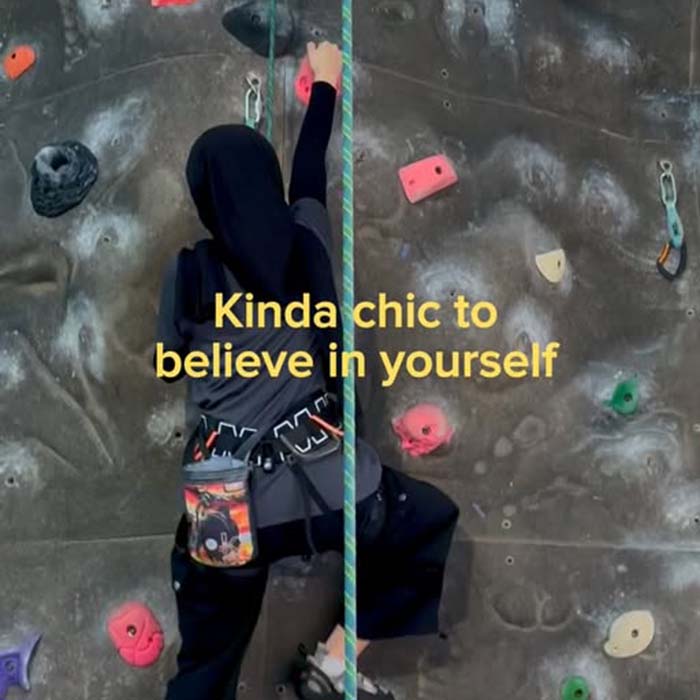 TU student climbing with copy that says "kinda chic to believe in yourself"