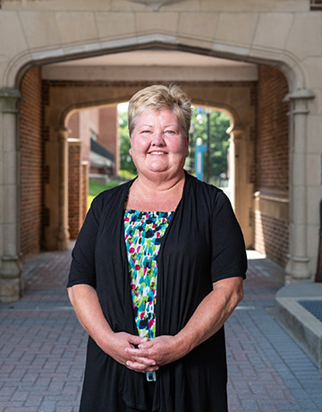 portrait in front of brick arch