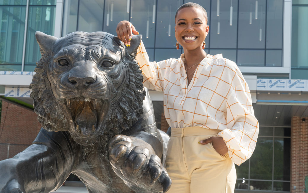 Jordan DeVeaux standing with the Tiger Statue near Tiger Plaza