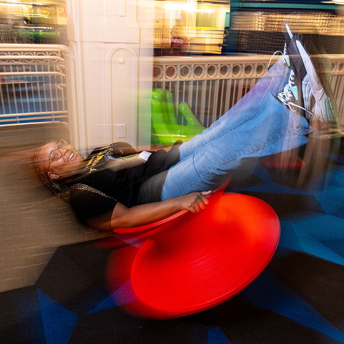Kennedi Harris spinning in a chair