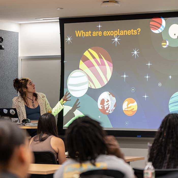 Ahmed Satti Tamsir Toure hold a large check after winning TU's college cup