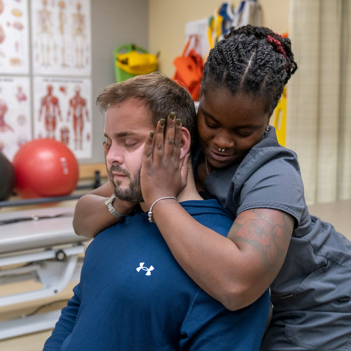 Students practice a spinal tension release rehabilitation technique