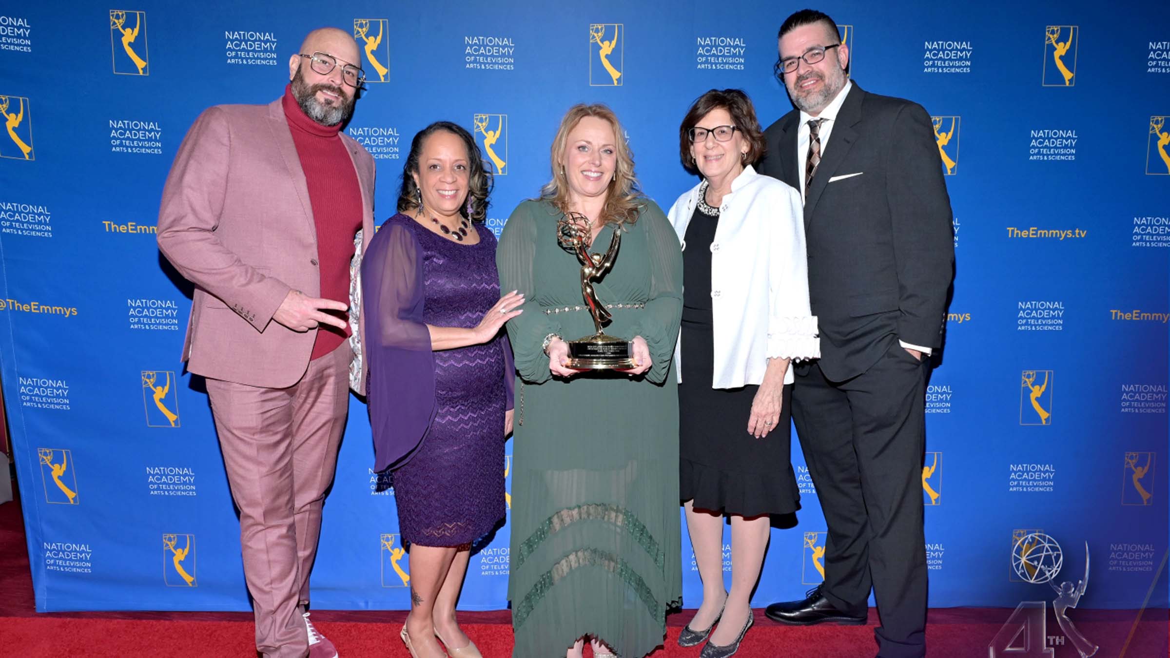 Krista Respass and her coworkers with an Emmy