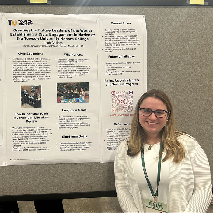 Student standing in front of poster