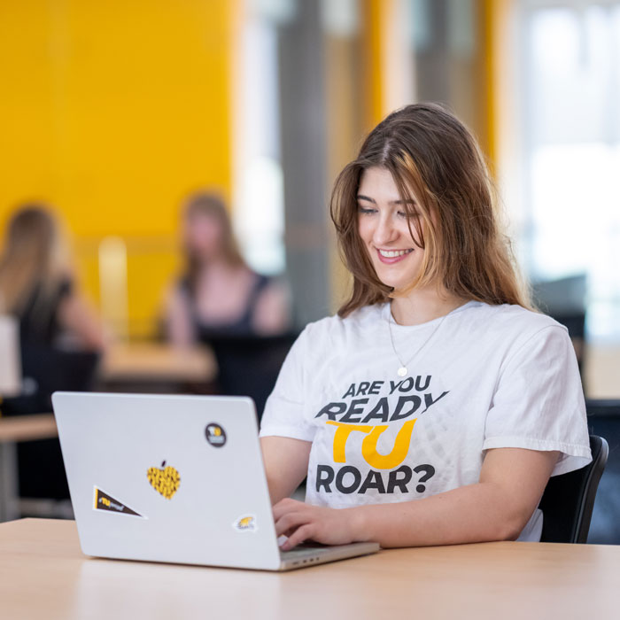 Lily Walton studying in a Towson University academic room 