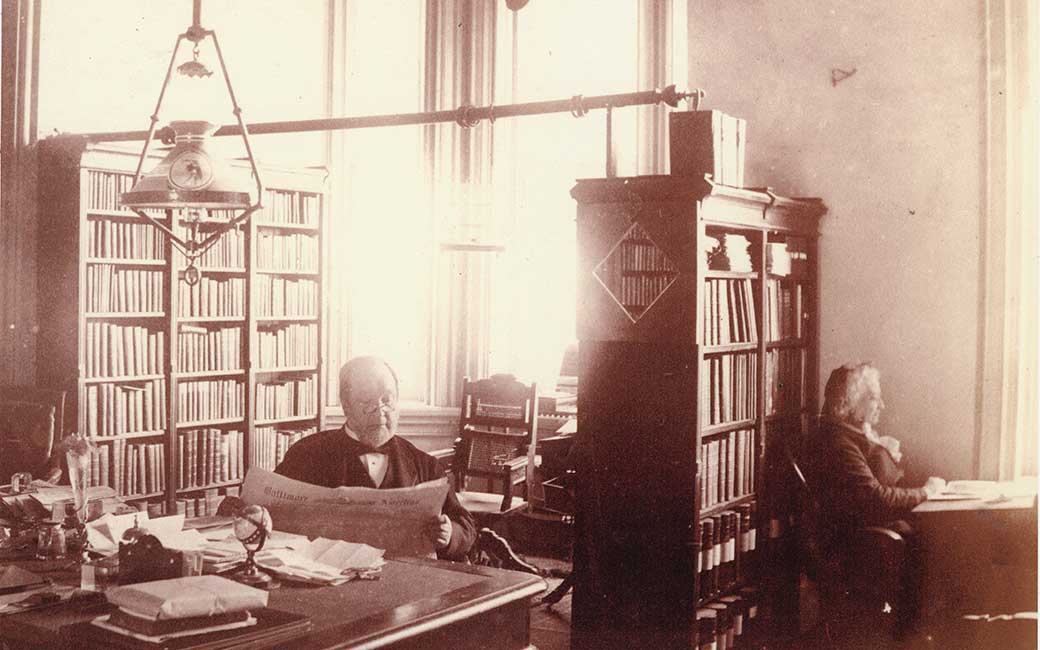 MA Newell sitting in his office