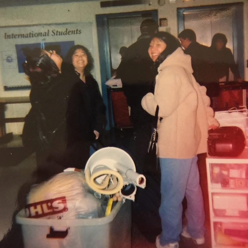 Two students moving into a dorm