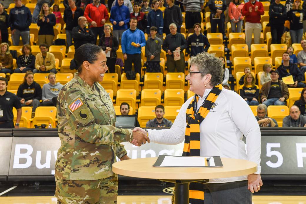 Towson University President Kim Schatzel shakes hands with Maryland Adjutant General Linda Singh after signing a Memorandum of Understanding between Towson University and the Maryland National Guard. The signing took place before Towson Men's Basketball game on Saturday, January 27.