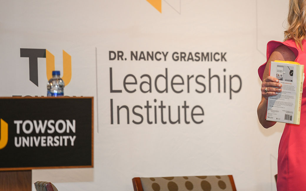 Phot of TU podium and Dr. Nancy Grasmick Leadership Institute logo