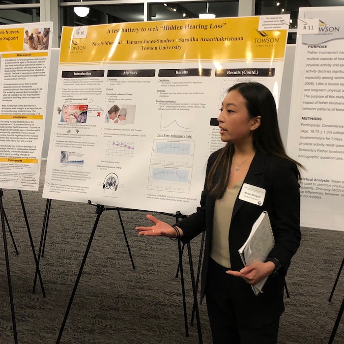 Female student presenting a poster