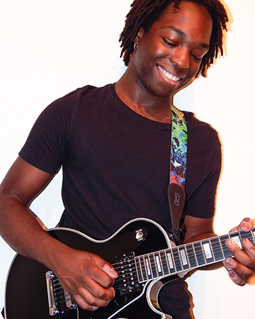 Noah Pierre playing guitar