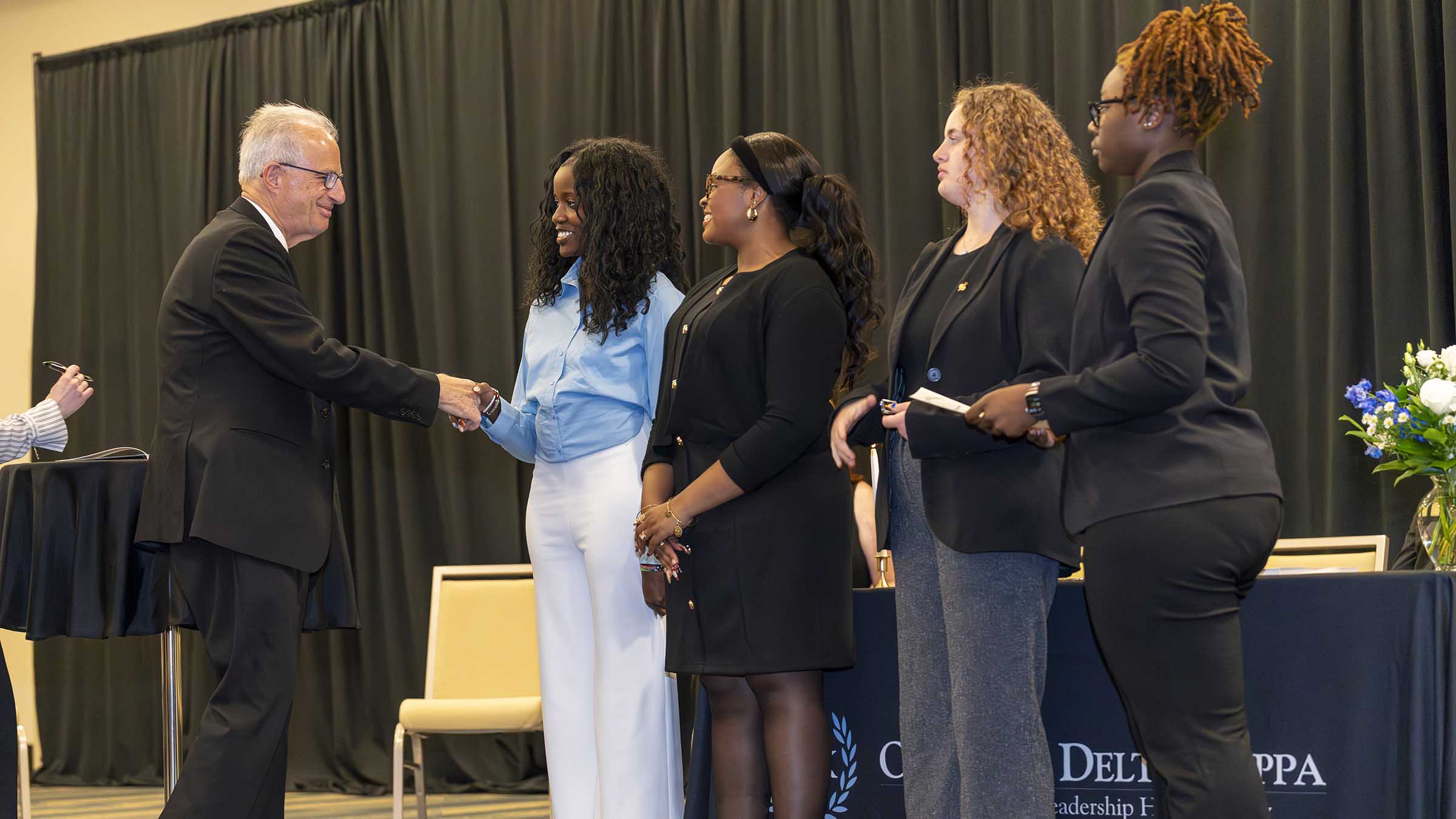 Ginsberg shaking hands with ODK student leaders