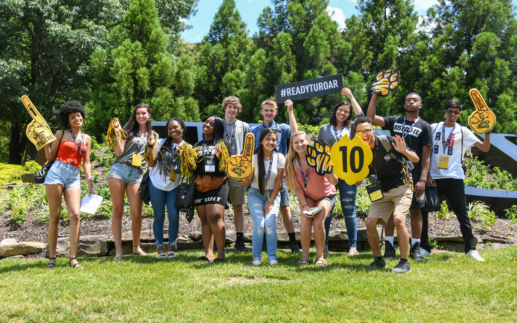 New students pose with thier orientation leader outside the TU