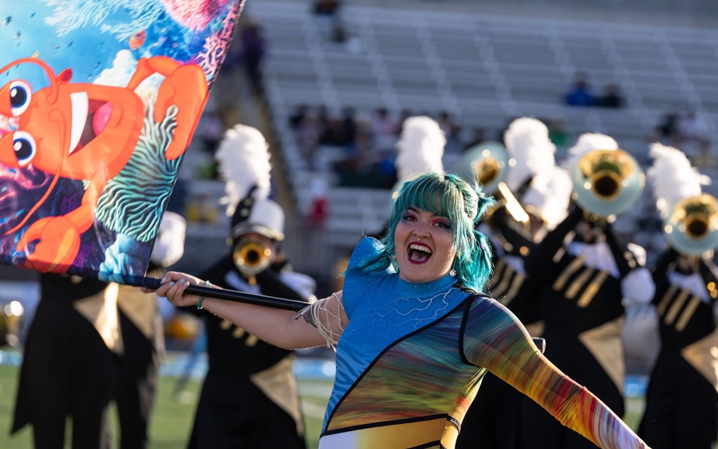 Paige Detwiler performing as a member of Towson's marching band and their color guard