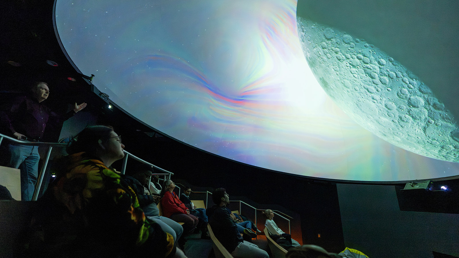 students, faculty, staff and community members at a planetarium show at towson university 