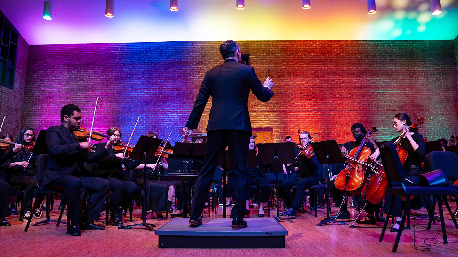 Orchestra and conductor playing music