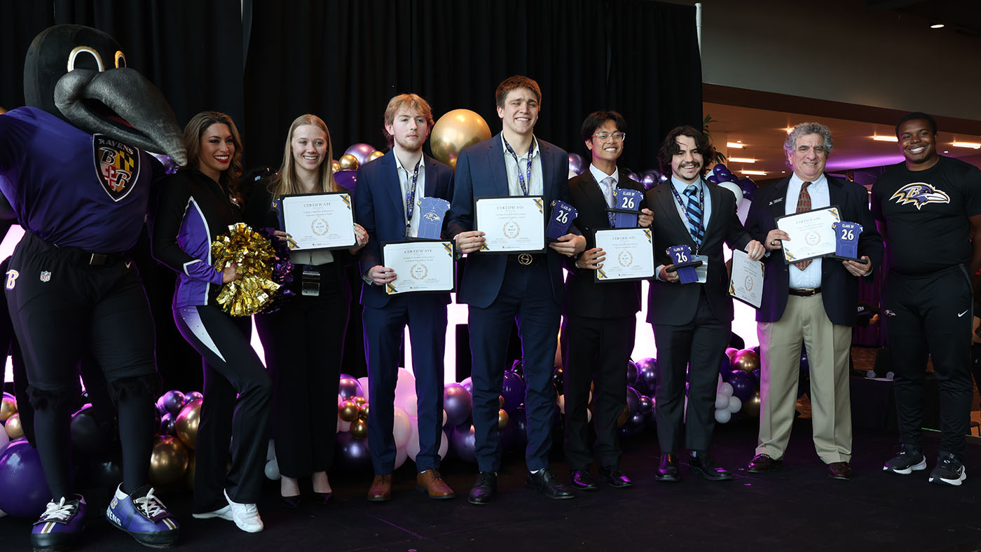 Group of winning team with Poe and cheerleaders