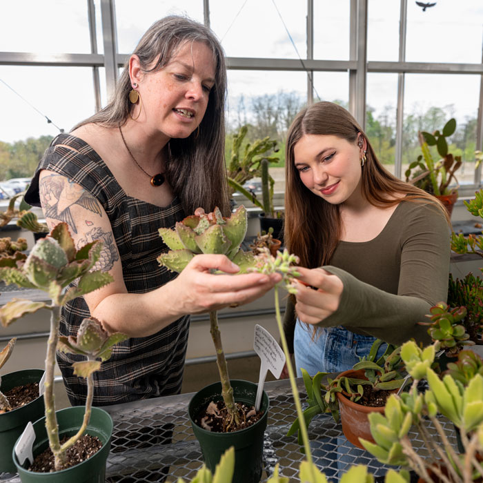 Towson Student Rebecca Harasymczuk looks over plants with Sustainability Outreach Coordinator Beth Schap