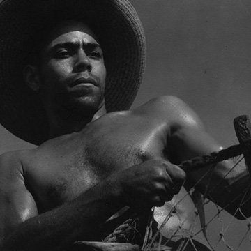 Black and white film still of laborer