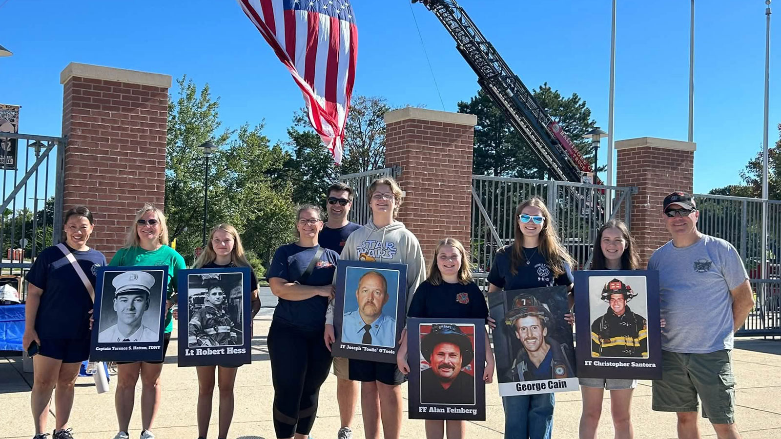 Participants in the Remembrance Walk hold photos of first responders who lost their lives during the September 11 attacks