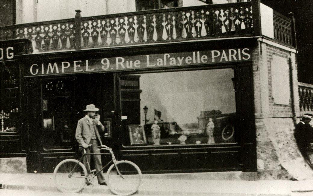 Black and white historical photo of shop with sign reading "Gimpel 9 Rue Lafayelle Paris"