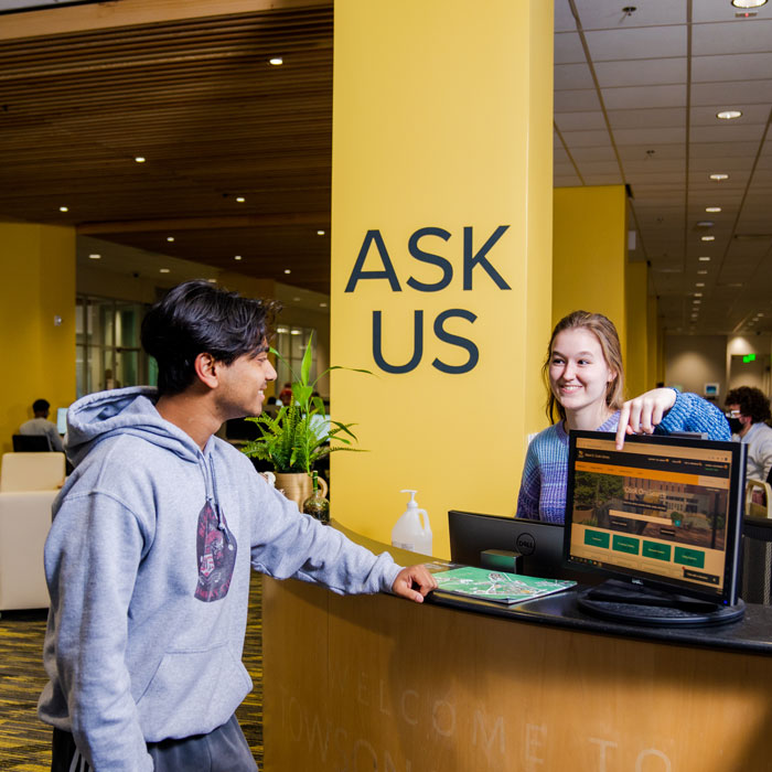 Student receives help at the Academic Commons' help desk