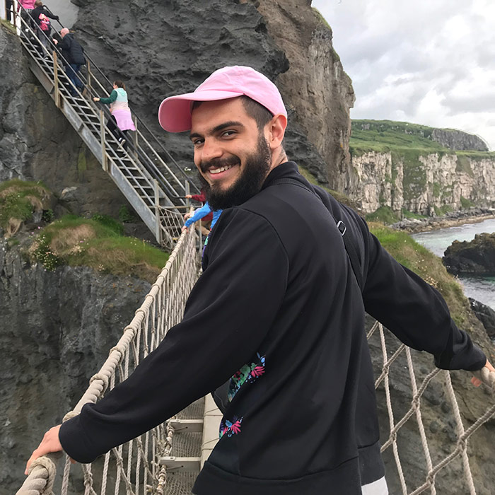 Man posing on cliff walkway