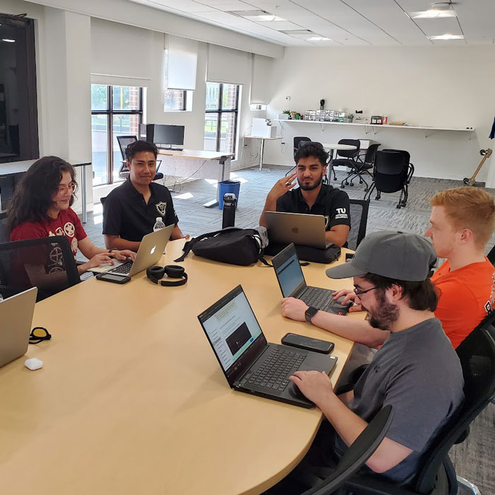 Students in the Sec Ops Research Team working collaboratively in the Cyber Center