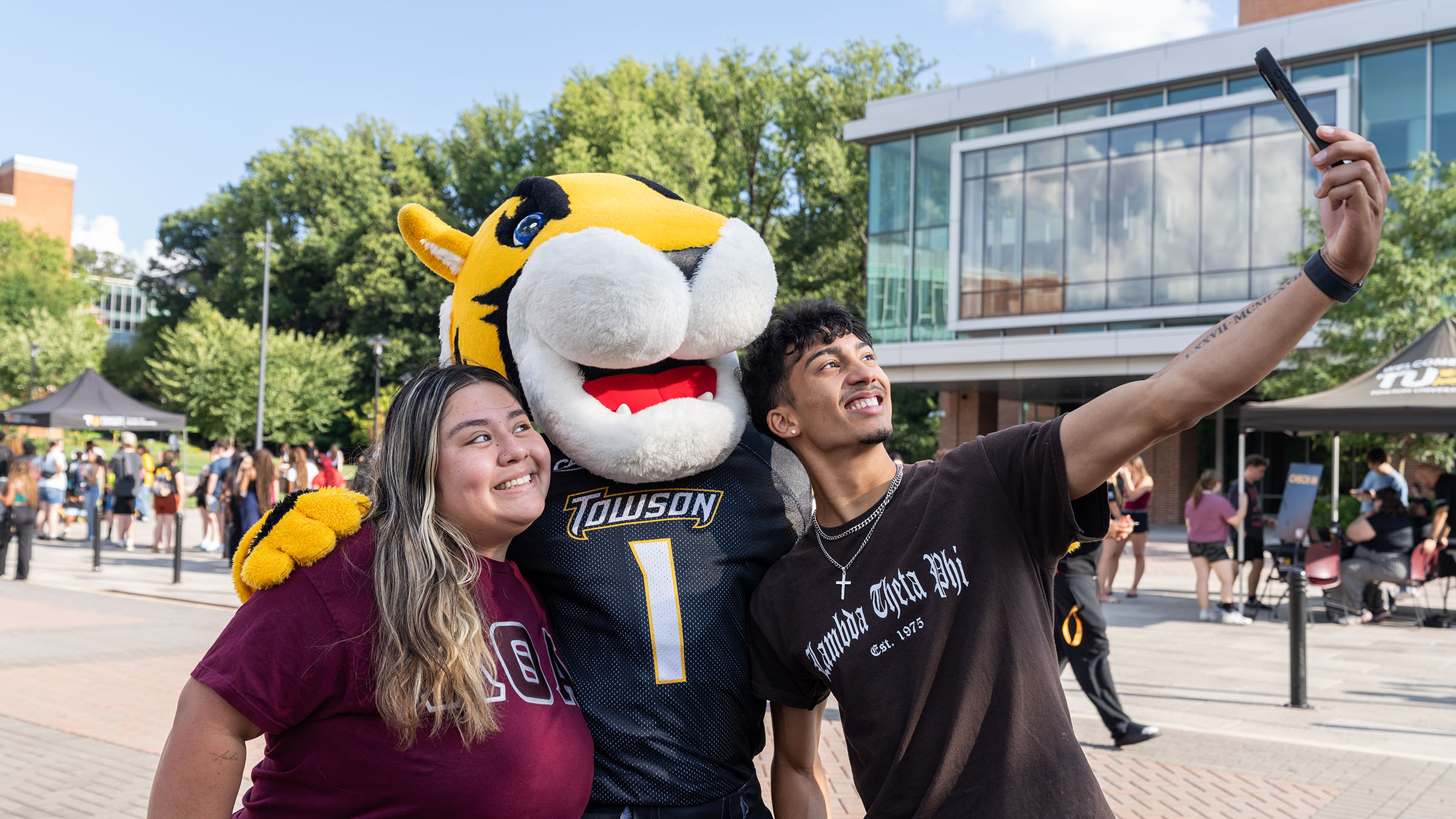 Doc the Tiger and TU students pose for a selfie.