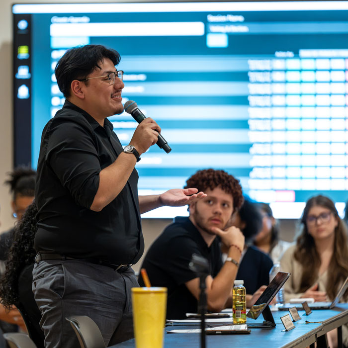 A student director addresses the SGA General Assembly Meeting