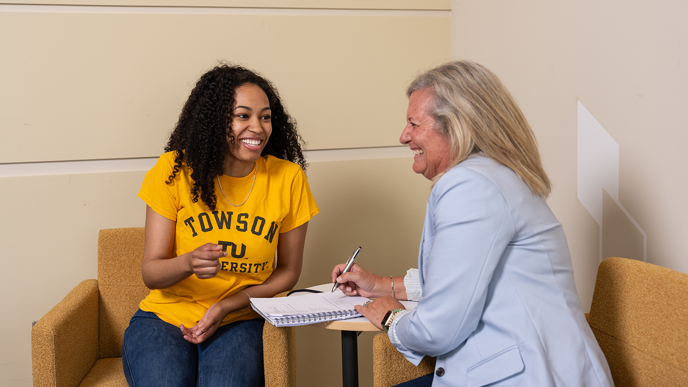 Student with professor sitting at table