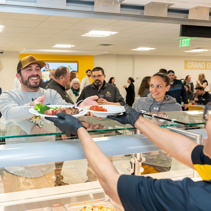 A member of the TU community getting food from Doc's South Campus Kitchen