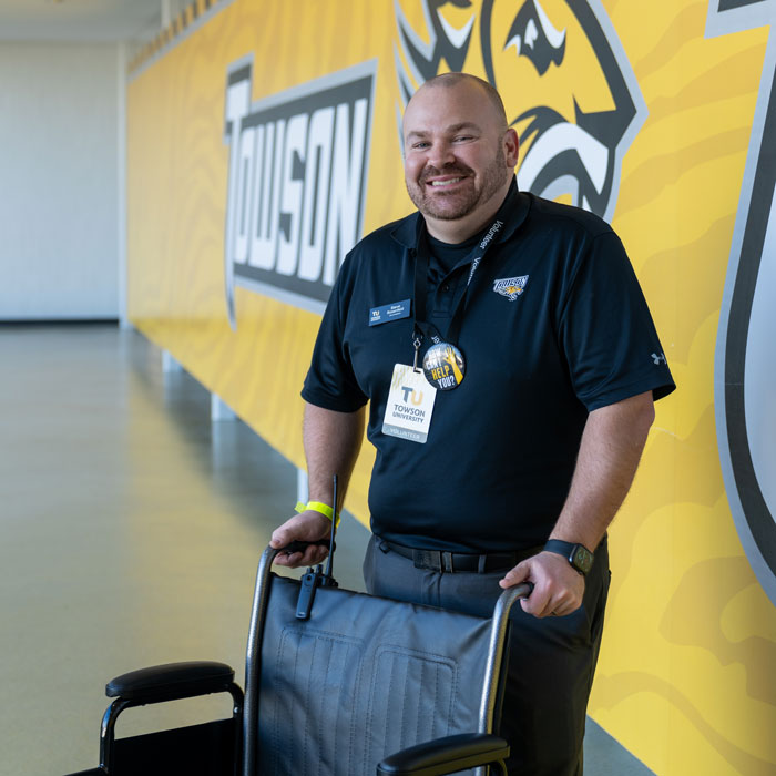 Staff member Stephen Rosenfeld volunteering for guests utilizing wheelchair access